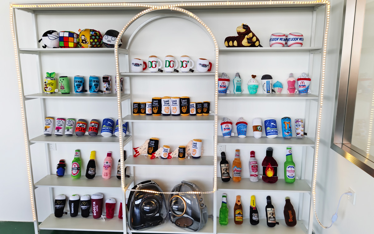 Pet plush toy beverage and can shapes on display shelves